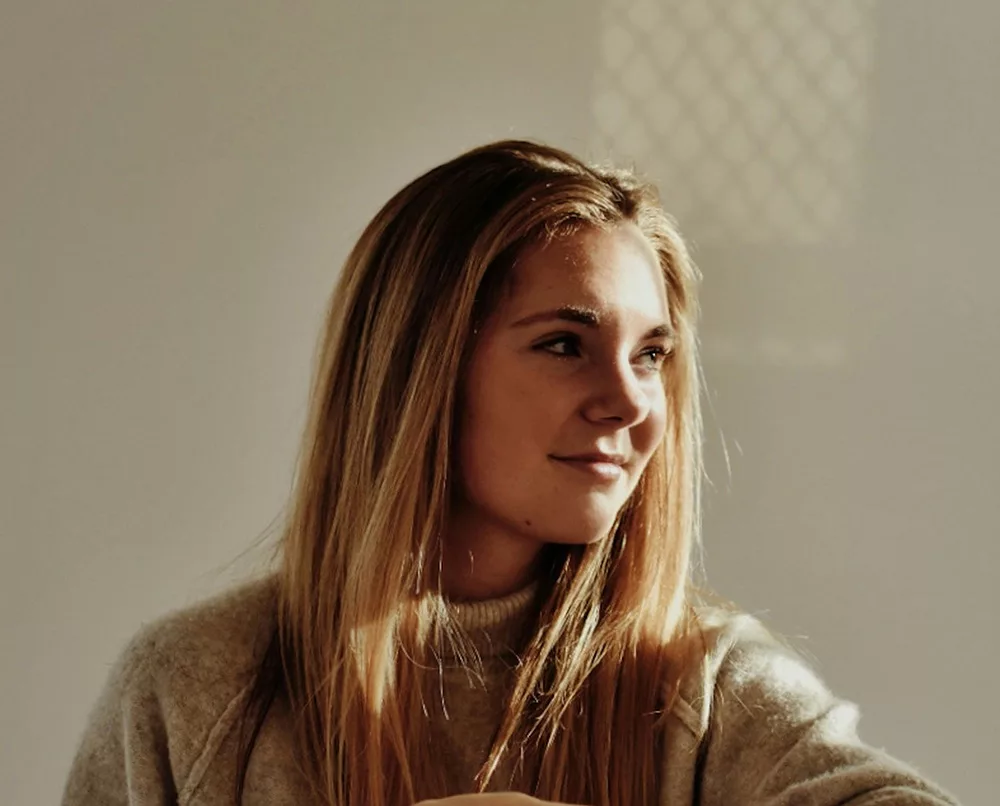 Woman smiling with sun shining on face